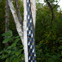 blue old man of the mountain necktie with New Hampshire design hanging from a tree
