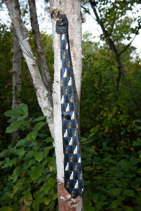 blue old man of the mountain necktie with New Hampshire design hanging from a tree